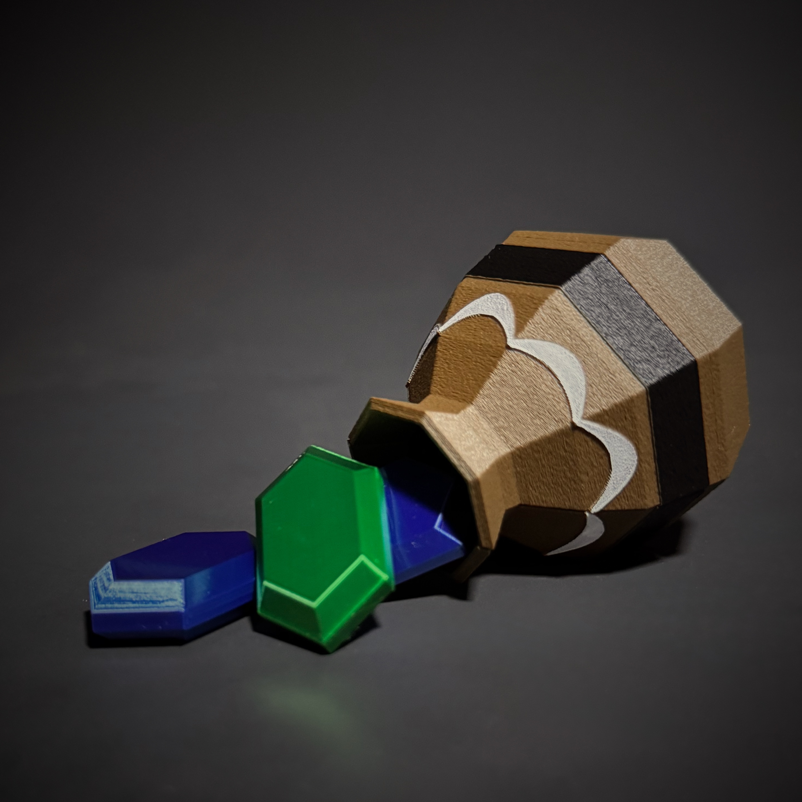 Brown 3D-printed pot on its side with a green rupee and a blue rupee sliding out
