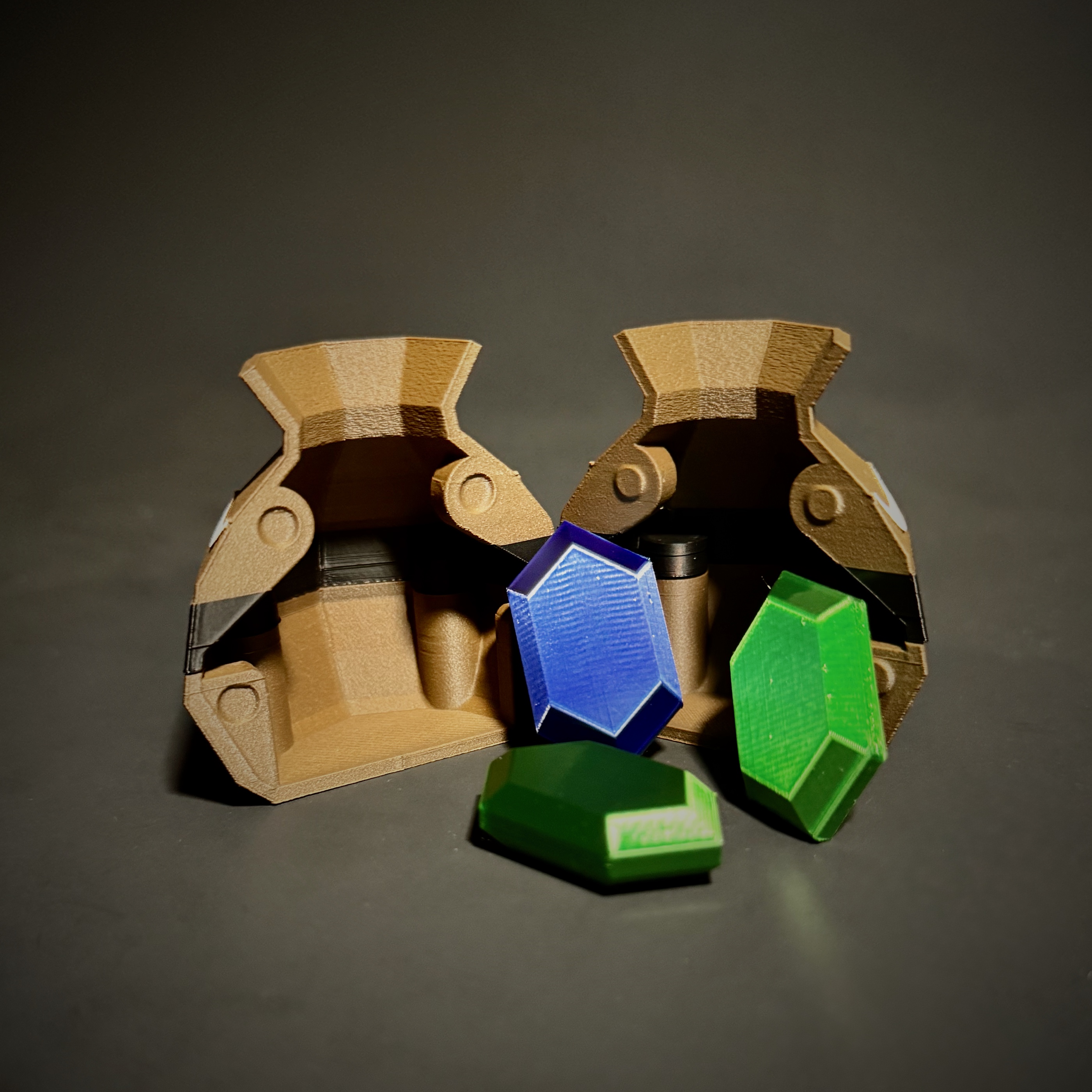 Two 3D-printed pot halves showing internal magnets and green and blue printed rupees